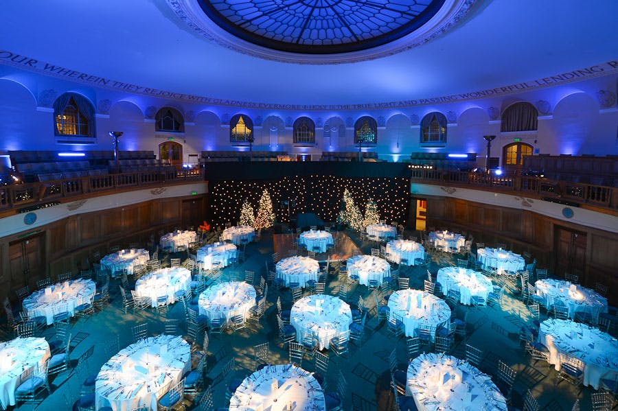 Christmas event at Church House Westminster with elegant blue table linens and festive decor.