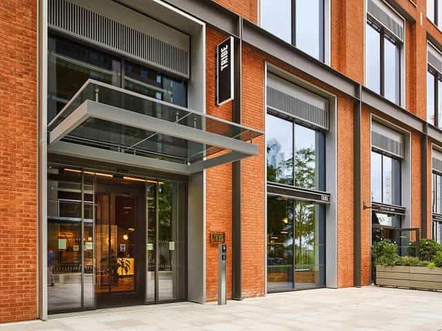 Modern TRIBE Hotels venue in Canary Wharf with sleek glass entrance for events.