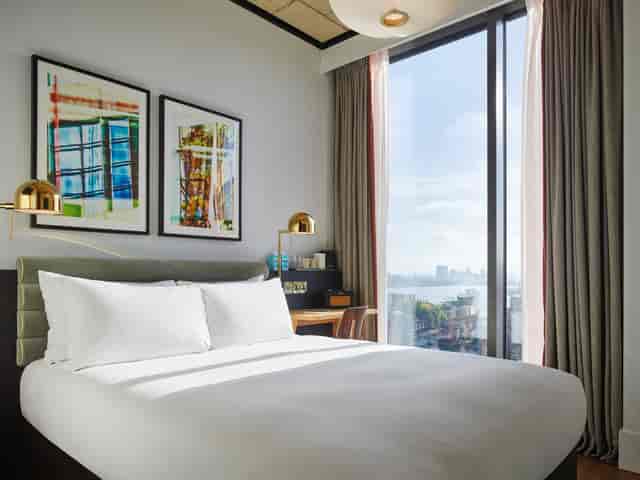 Modern hotel room at TRIBE Hotels, Canary Wharf, perfect for business events and meetings.