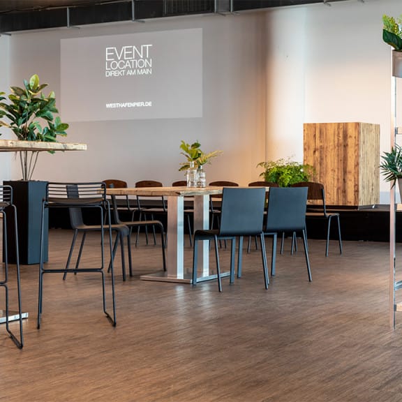 Modern event space at Pier 1, Westhafen, with sleek furniture for meetings and presentations.