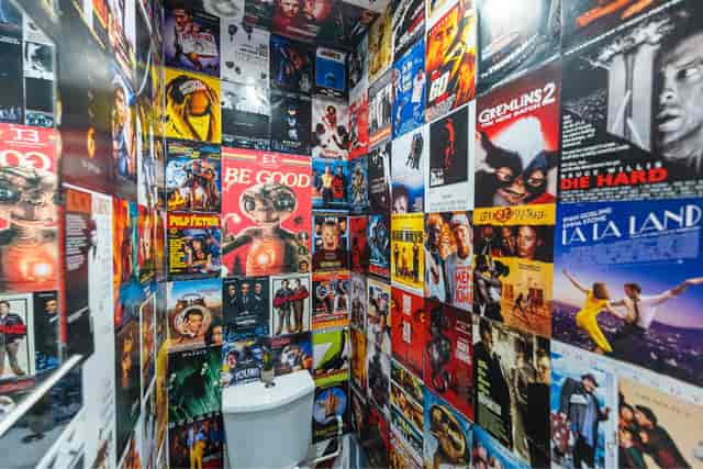 Vintage movie poster restroom at 6 Degrees Studios for unique event experiences.