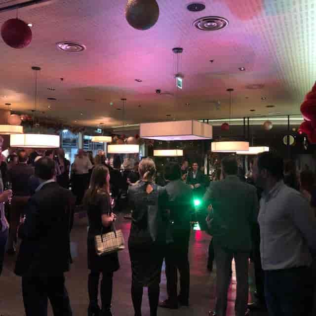 Vibrant networking event in stylish Ping Pong Bow Bell's House with engaged attendees.