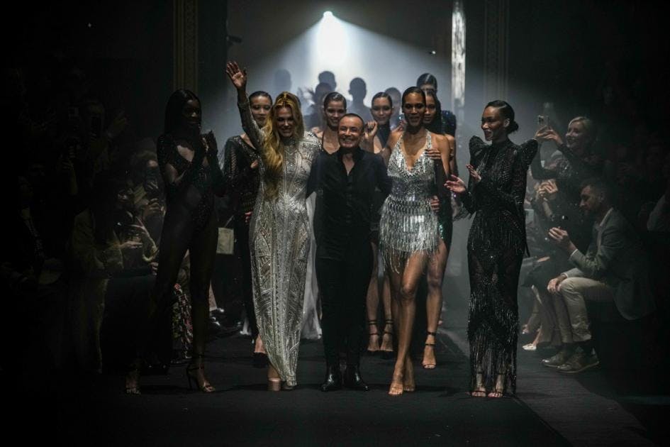 Glamorous fashion show finale at The Grand Temple, showcasing elegant attire and ambiance.
