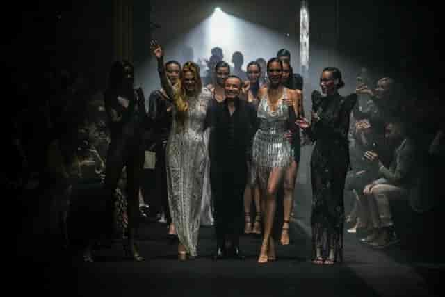 Glamorous fashion show finale at The Grand Temple, showcasing elegant attire and ambiance.