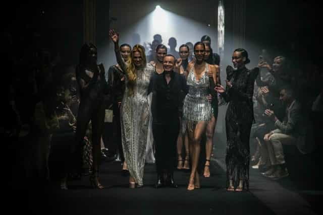 Glamorous fashion show finale at The Grand Temple, showcasing elegant attire and ambiance.