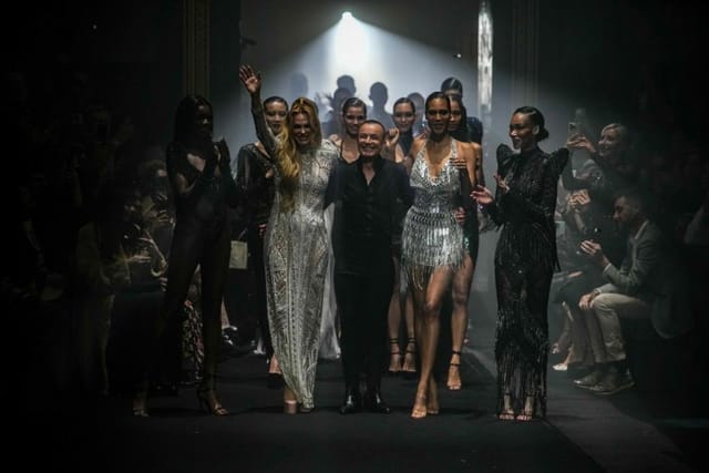 Glamorous fashion show finale at The Grand Temple, showcasing elegant attire and ambiance.