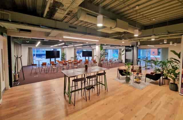 Versatile event space with flexible seating for meetings and social gatherings.