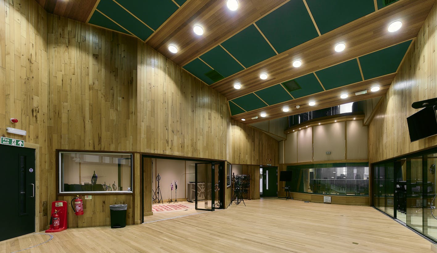 Spacious event space at Angel Studios with high wooden ceilings, ideal for meetings and workshops.