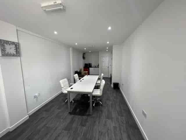 Modern meeting room with white table, ideal for presentations and discussions in Strood.