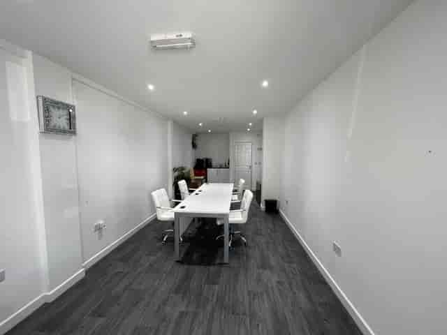 Modern meeting room in Strood with white table, ideal for workshops and discussions.