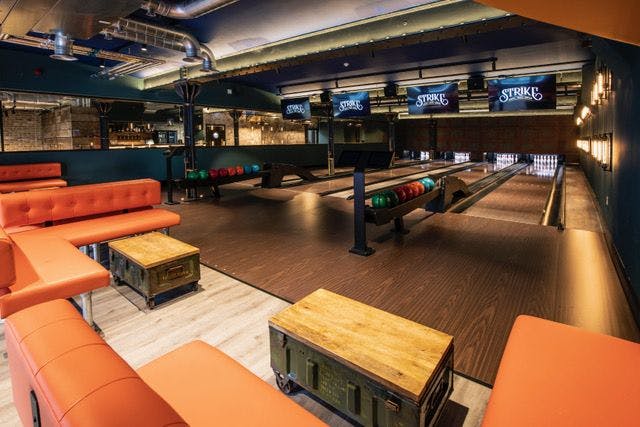 Vibrant bowling alley venue for team-building and corporate events with modern decor.