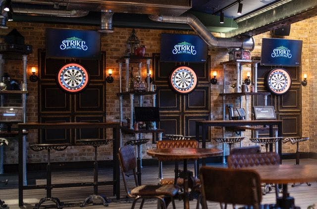 Vibrant Strike Bowling event space with dartboards for team-building and networking.