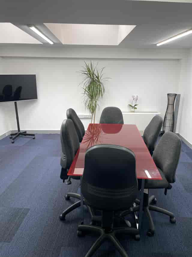Modern meeting room with polished table, ideal for presentations and conferences.