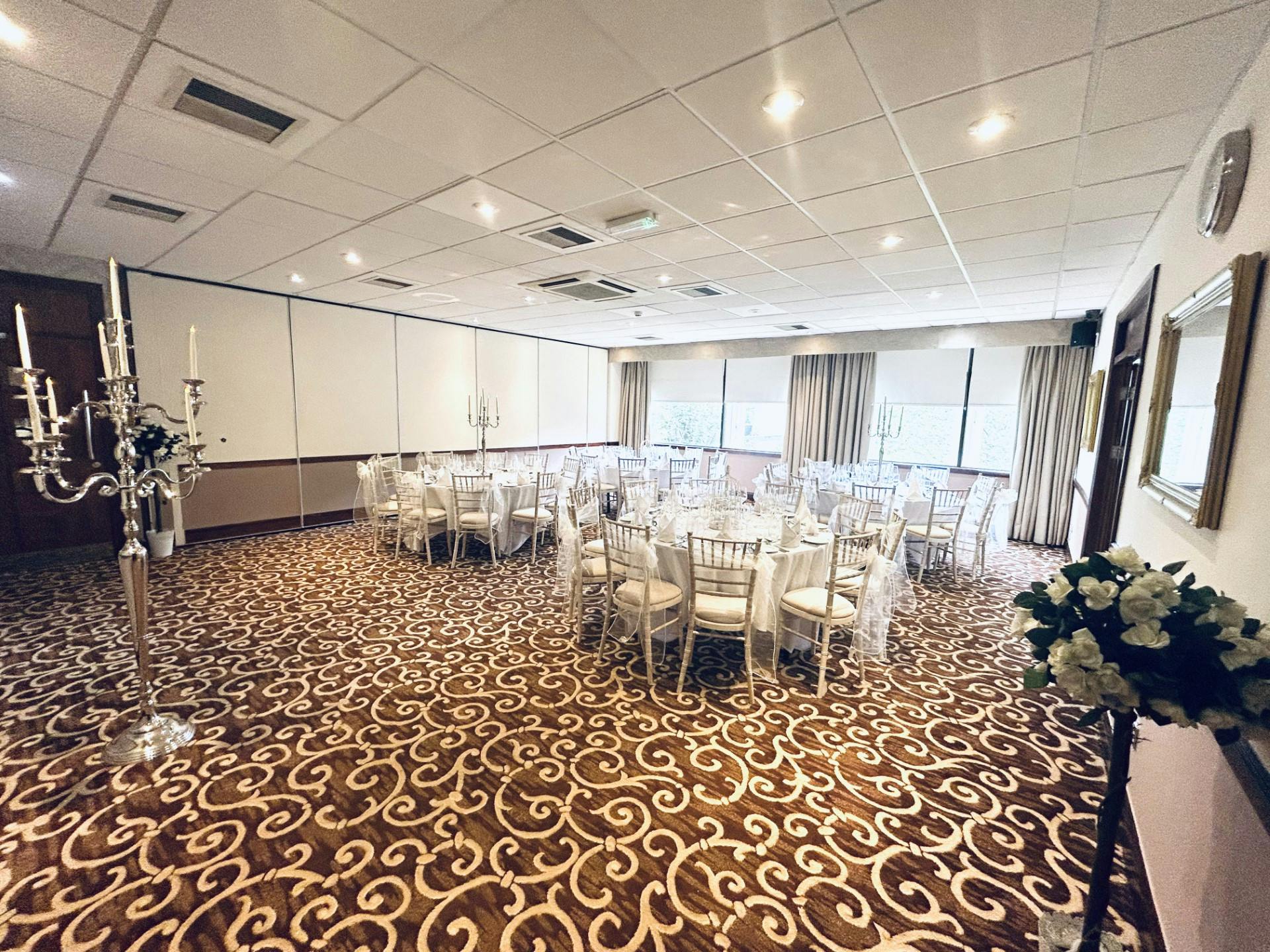 Elegant event space with round tables, perfect for weddings and corporate events.