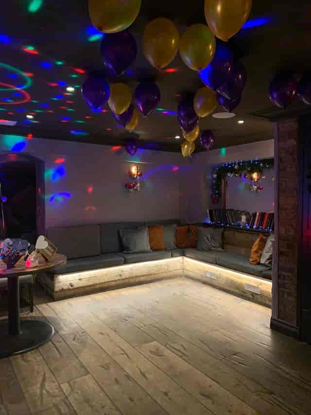 Cozy garden room with ambient lighting, perfect for casual gatherings and celebrations.