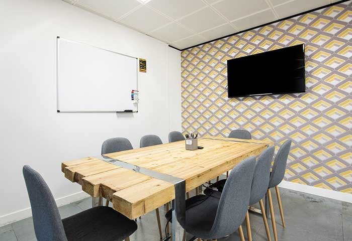 Modern meeting room with rustic wooden table for collaborative events in Bristol.