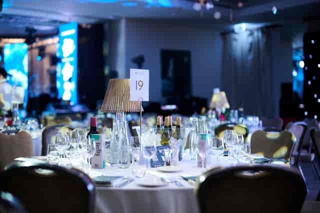 Gala event setup in The Hurlingham Club Palm Court with crisp linen table settings.