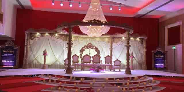 Elegant Meridian Ballroom stage with chandelier, perfect for weddings and formal events.