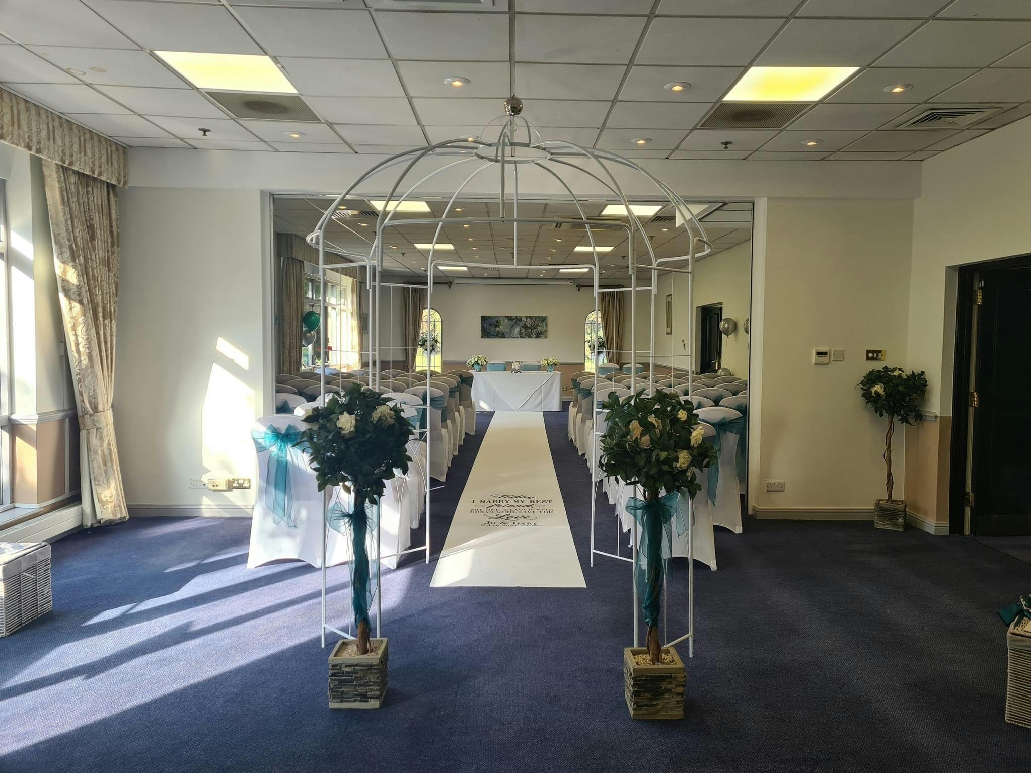 Elegant wedding setup at Meon Valley Hotel with floral arrangements and teal accents.
