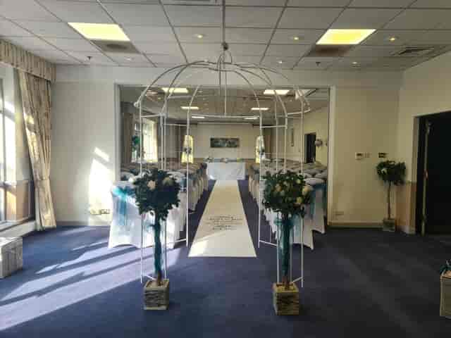Elegant wedding setup at Meon Valley Hotel with floral arrangements and teal accents.
