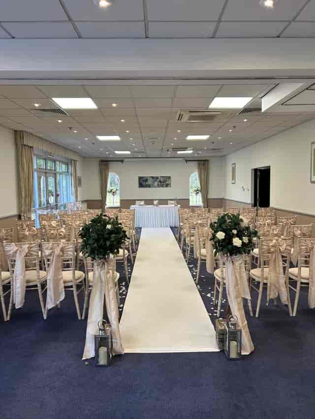 Elegant wedding venue at Meon Valley Hotel with floral accents and natural light.