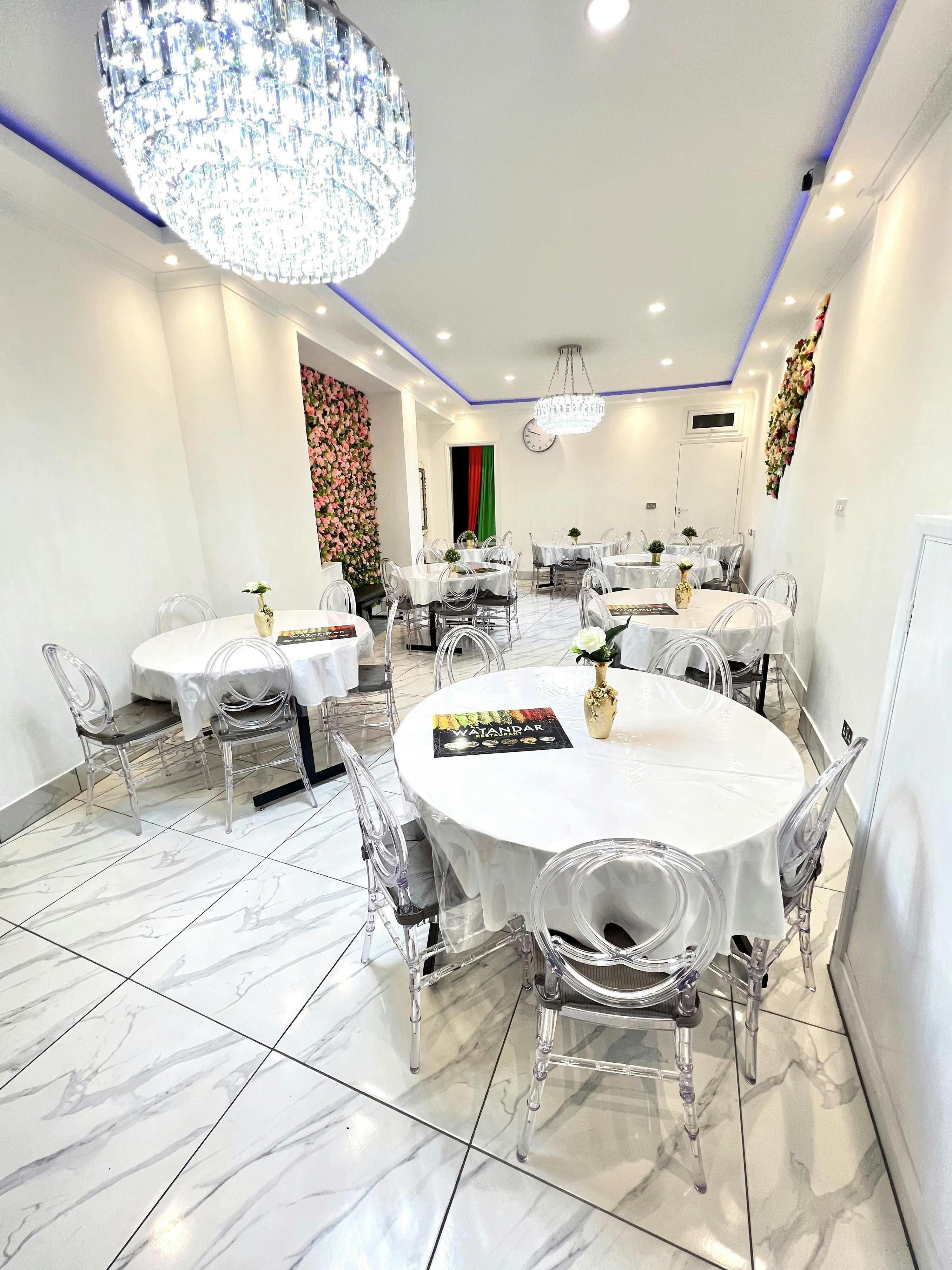 Elegant Watandar Hall with round tables, ideal for intimate gatherings and workshops.