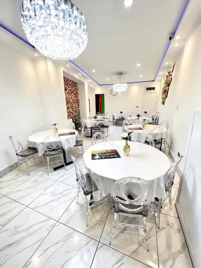Elegant Watandar Hall event space with round tables, ideal for intimate gatherings and workshops.