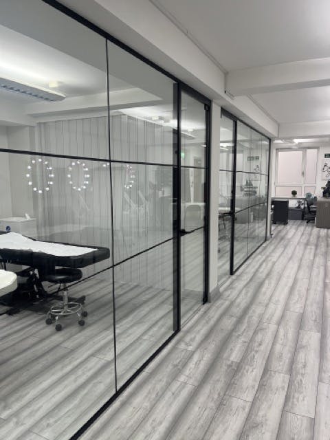 Modern event space in Beauty School Manchester with sleek glass partitions for workshops.