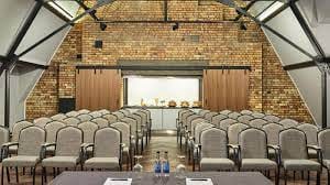 Telegraph Room at The Parkgate Hotel, modern meeting space with exposed brick walls.