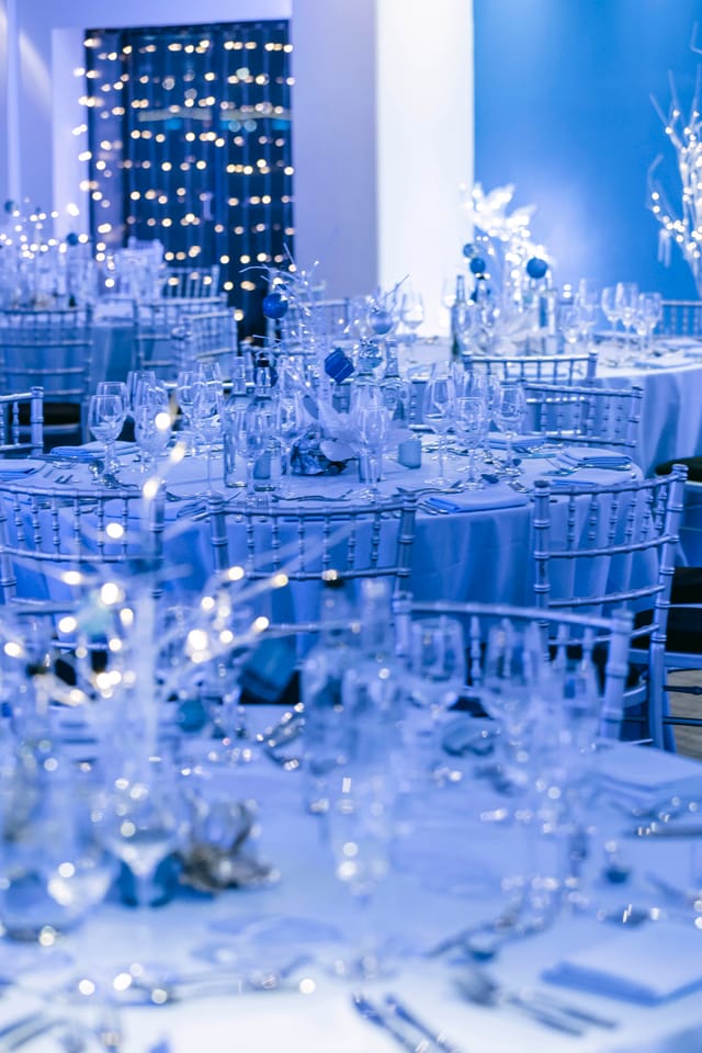 Elegant banquet space with blue linens, ideal for weddings and corporate galas.