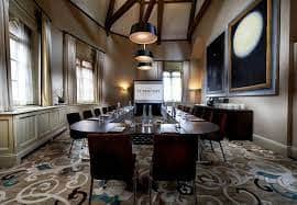 Elegant meeting room with oval table at St Pancras Renaissance Hotel for professional events.
