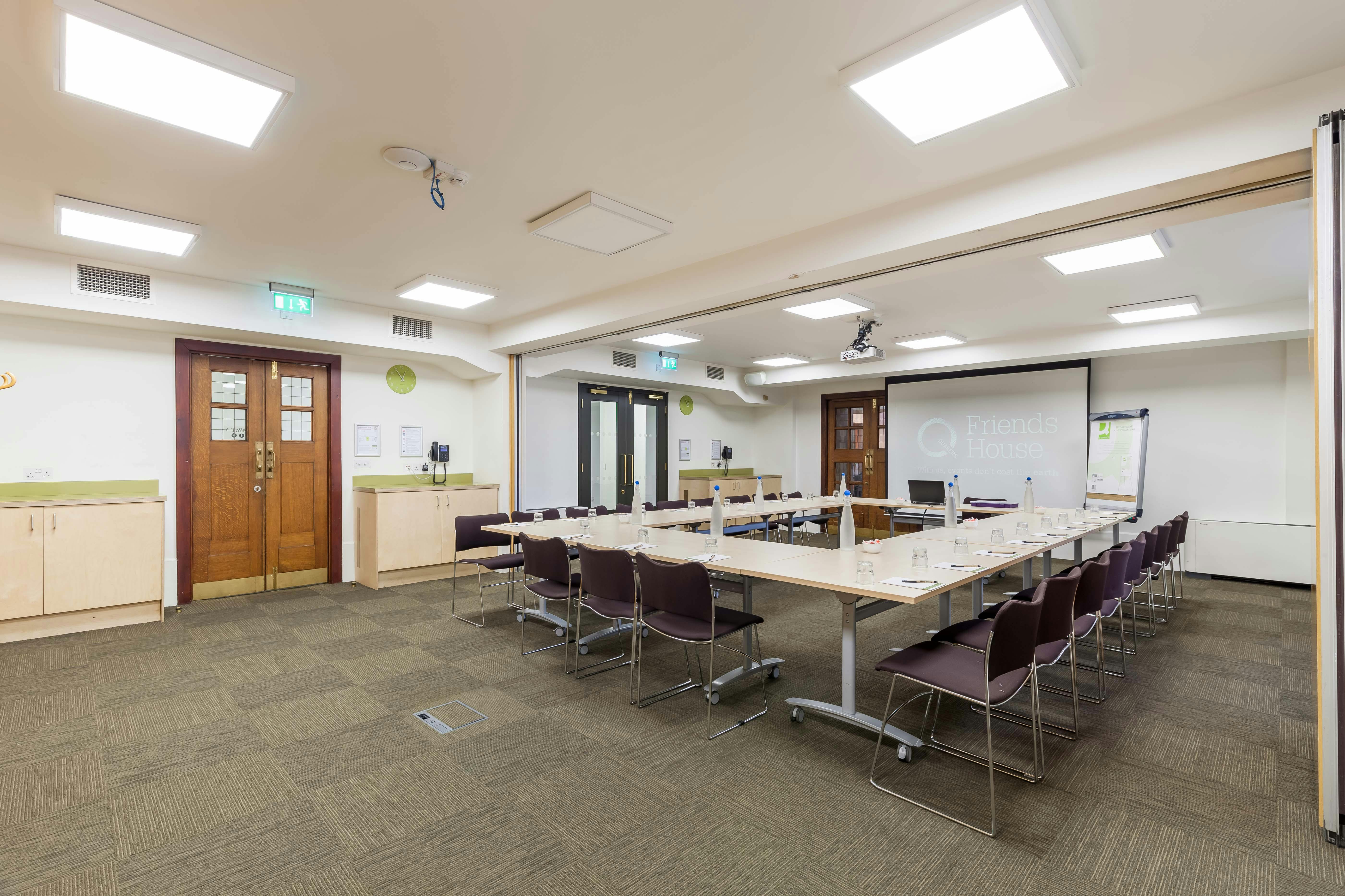 Ada Salter Suite meeting room with central table, ideal for collaborative events and presentations.