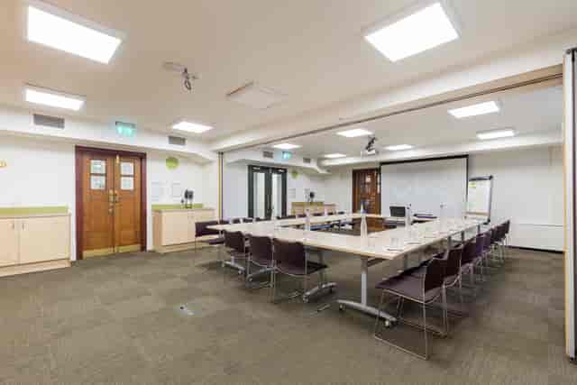 Ada Salter Suite meeting room with central table, ideal for collaborative events and presentations.