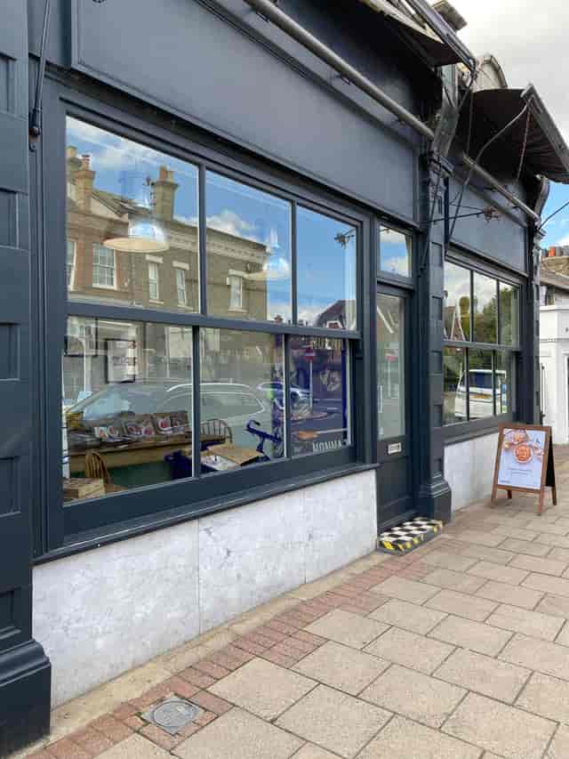 Charming event venue with large windows, perfect for meetings and workshops.