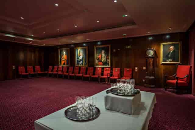Traditional courtroom boardroom with red seating for VIP meetings and formal events.