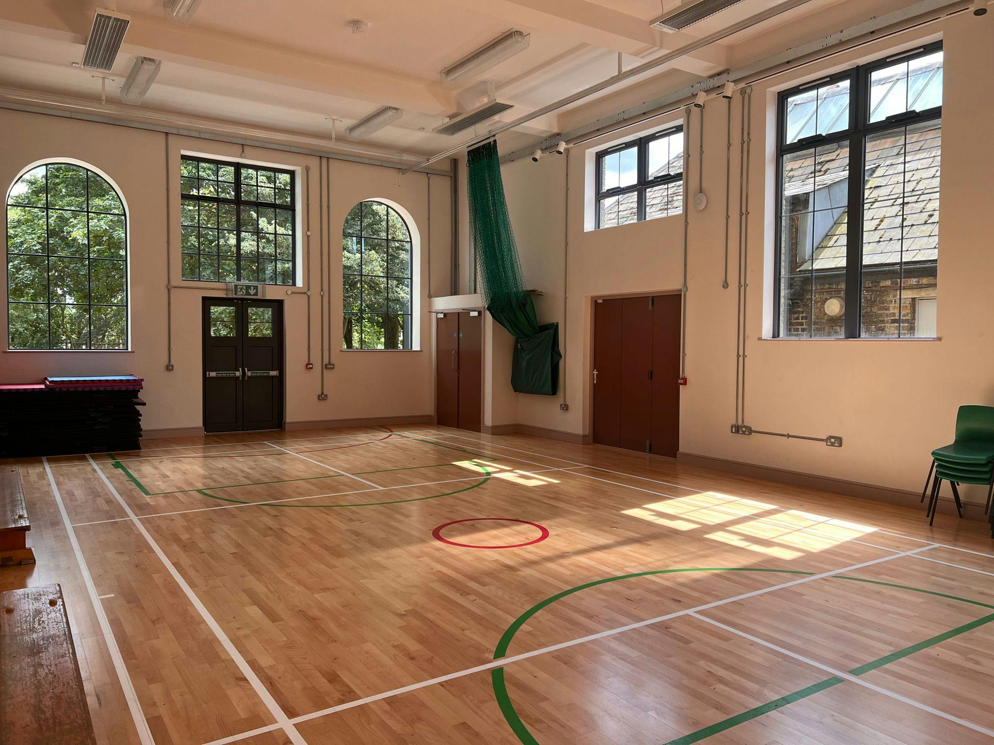 Hocking Hall: bright indoor event space with hardwood floor for meetings and workshops.