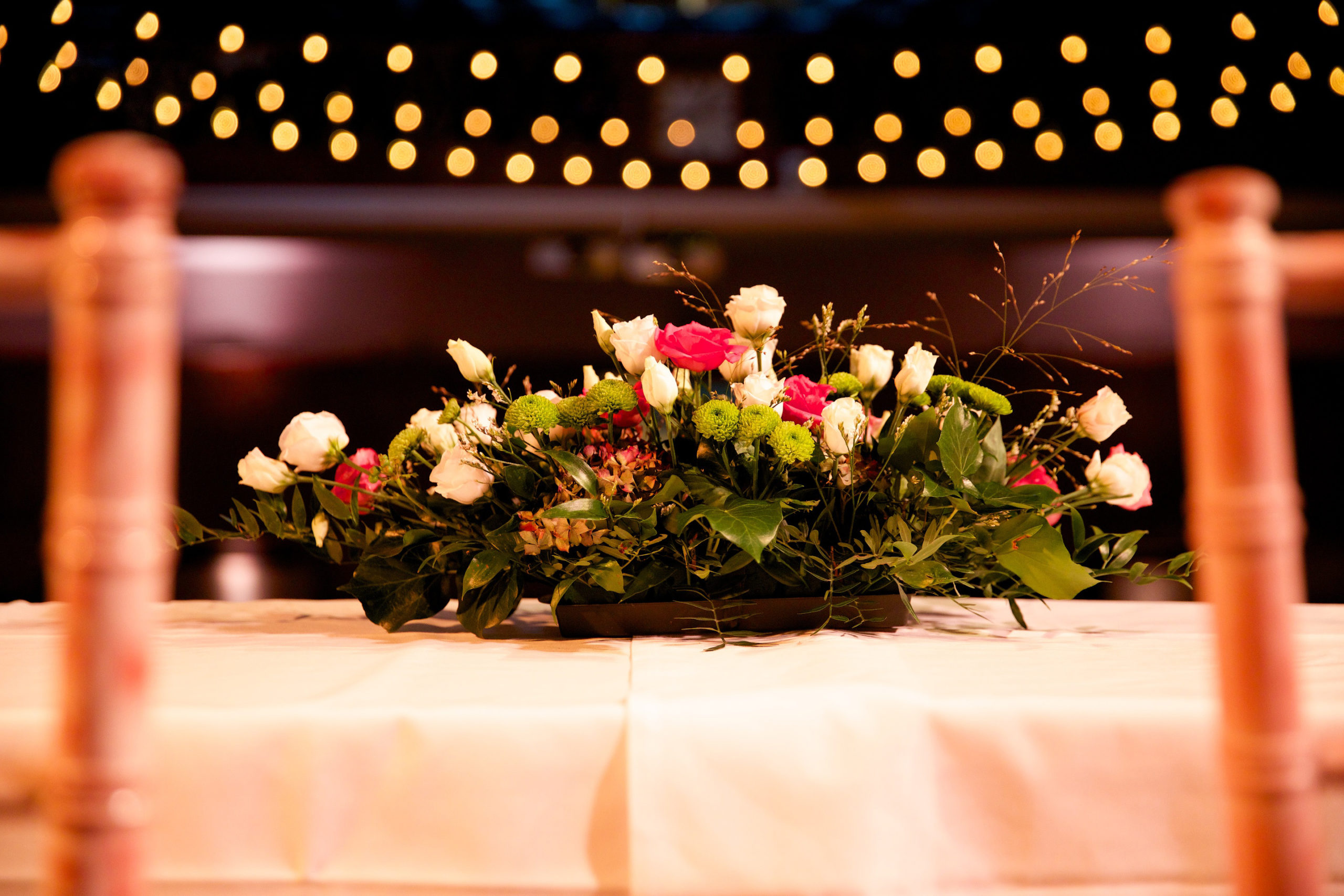 Floral centerpiece at Conway Hall wedding with soft lighting ambiance. - Banner