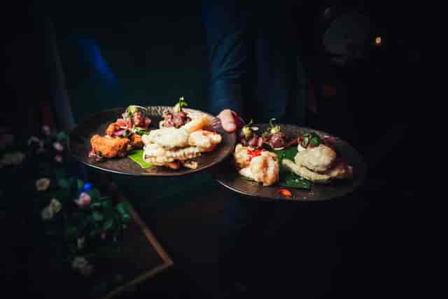 Elegant appetizers served at Club Royale London event, showcasing vibrant colors and textures.