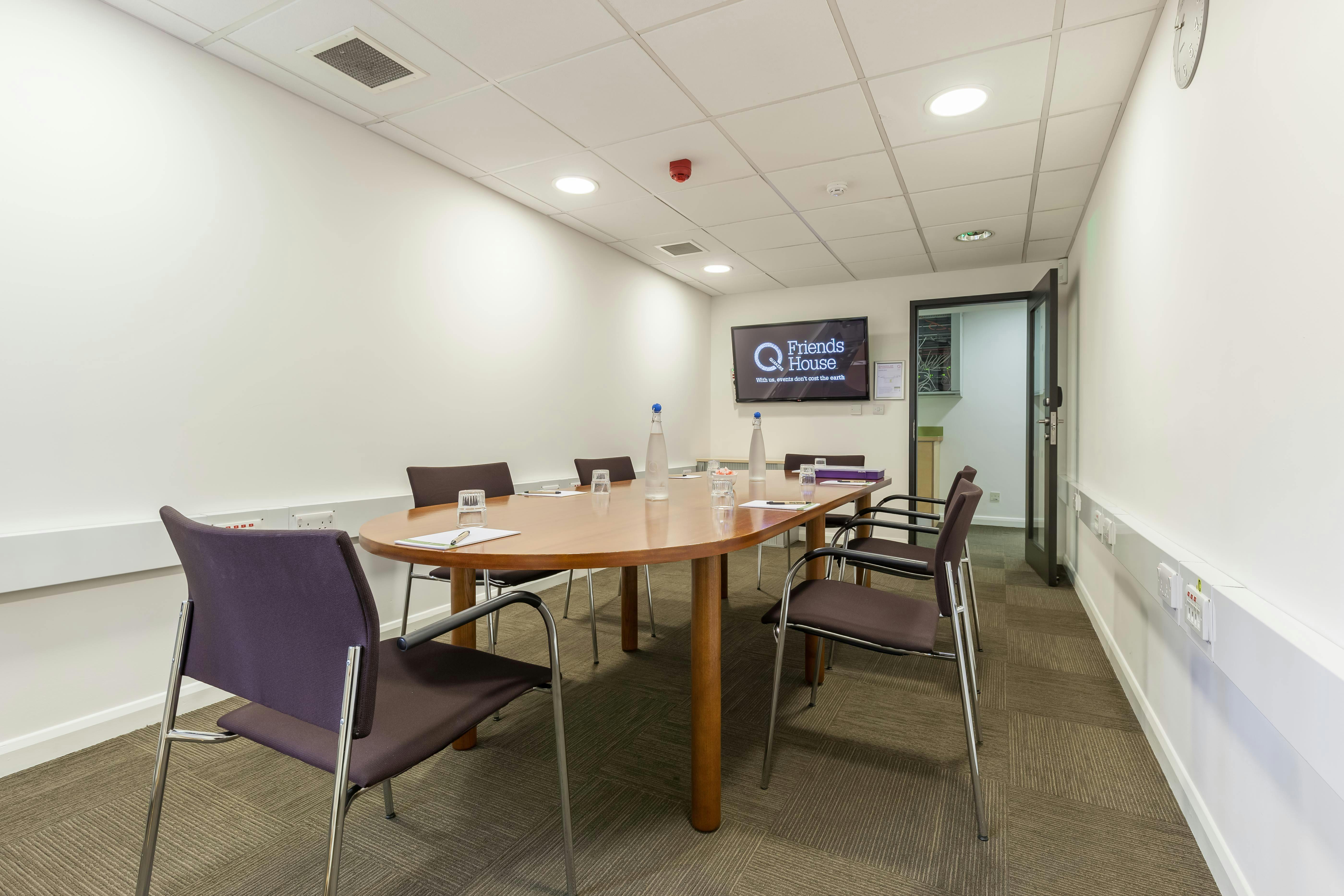 Lucretia Mott in a professional meeting room with round table for collaboration.