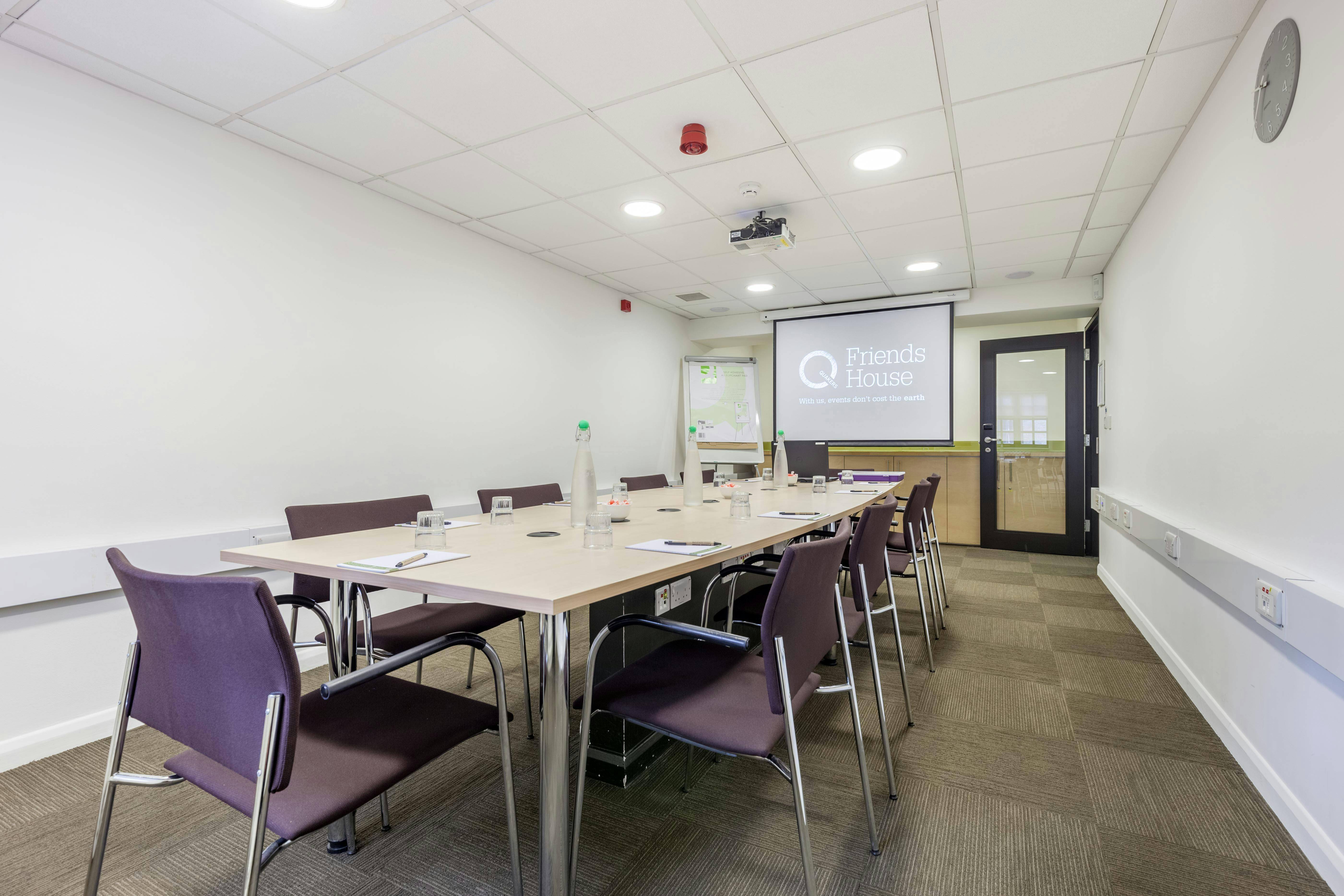 John Woolman in a modern meeting room with ergonomic chairs for professional gatherings.