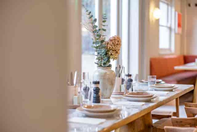 Elegant dining table in Jaego's House, perfect for intimate meetings and small events.