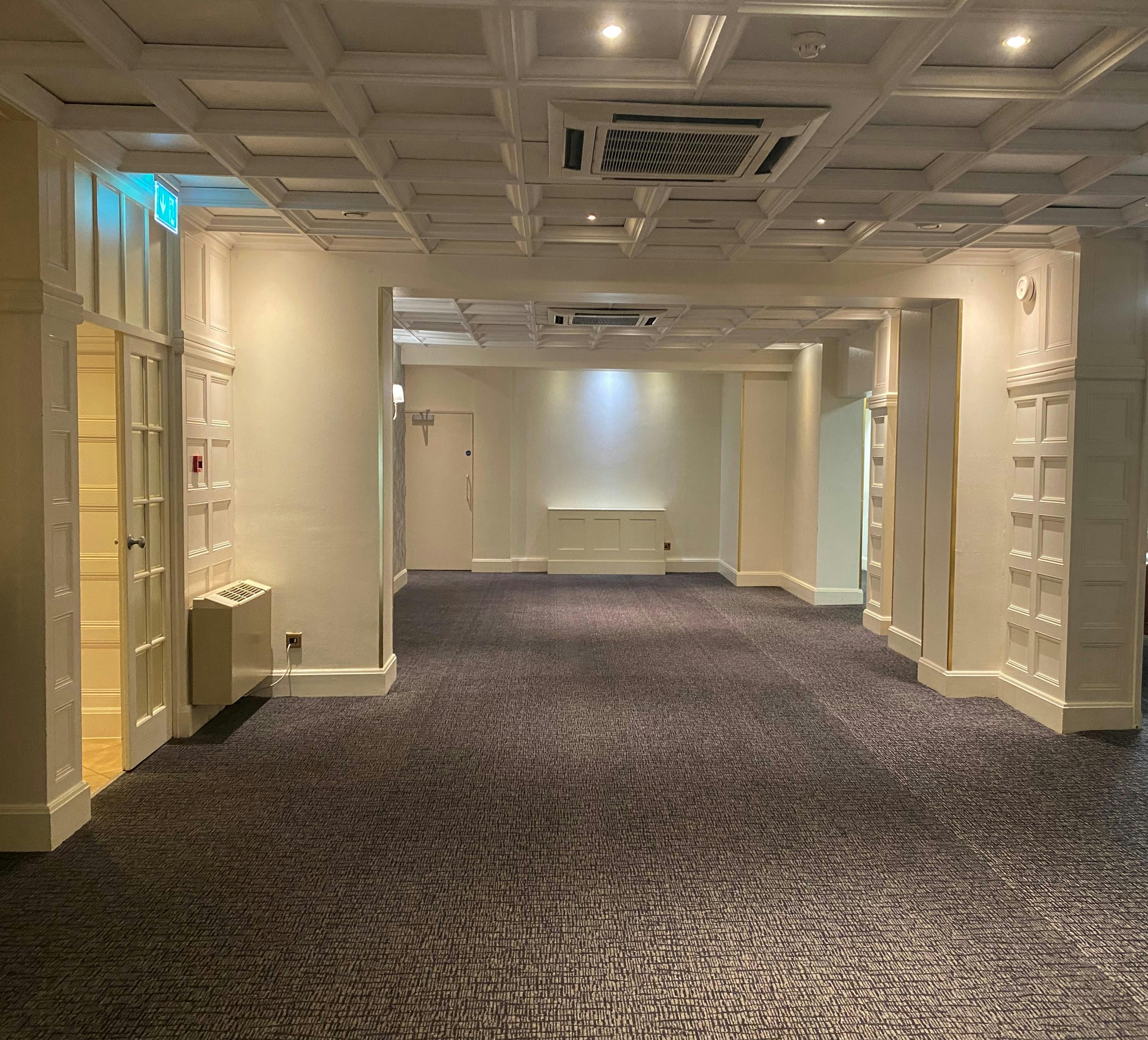 Versatile Manor room at Barton Manor Hotel, ideal for meetings and gatherings.