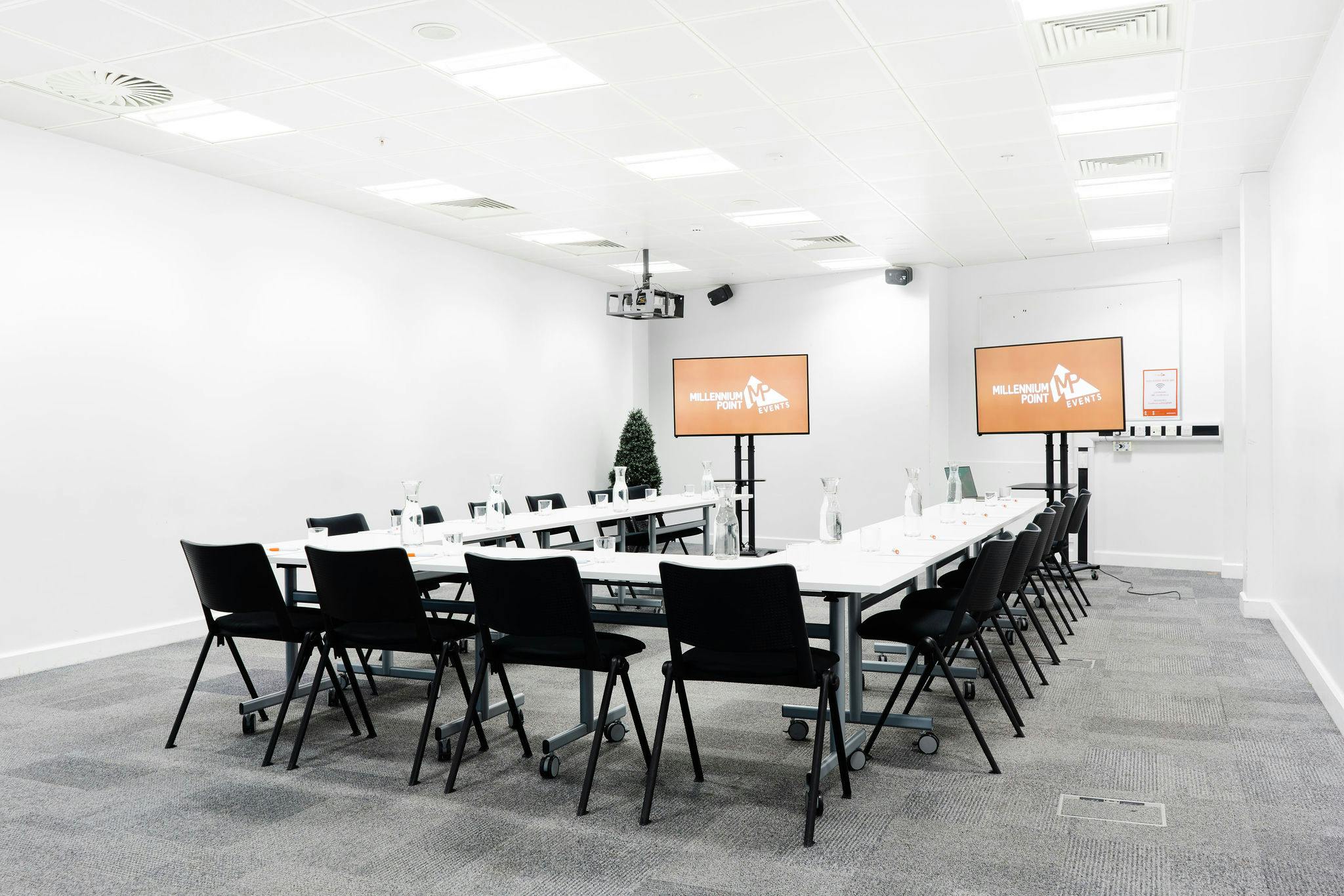 Modern meeting room at Millennium Point with large table, ideal for workshops and presentations.