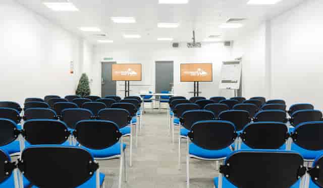 Curzon Rooms meeting space with blue chairs, ideal for presentations and events.