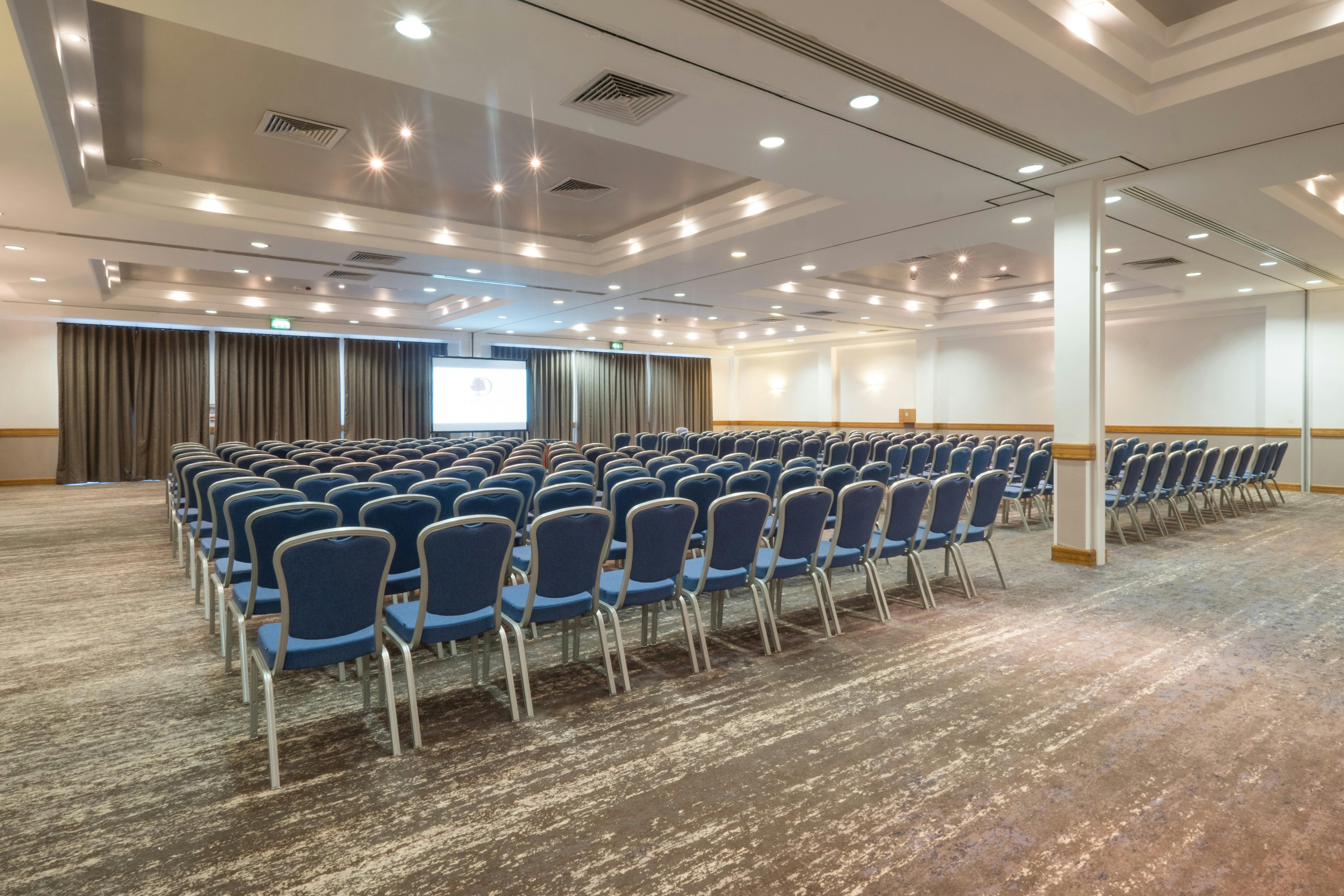 Lydiard Suite conference room with blue chairs for corporate events at DoubleTree Swindon.