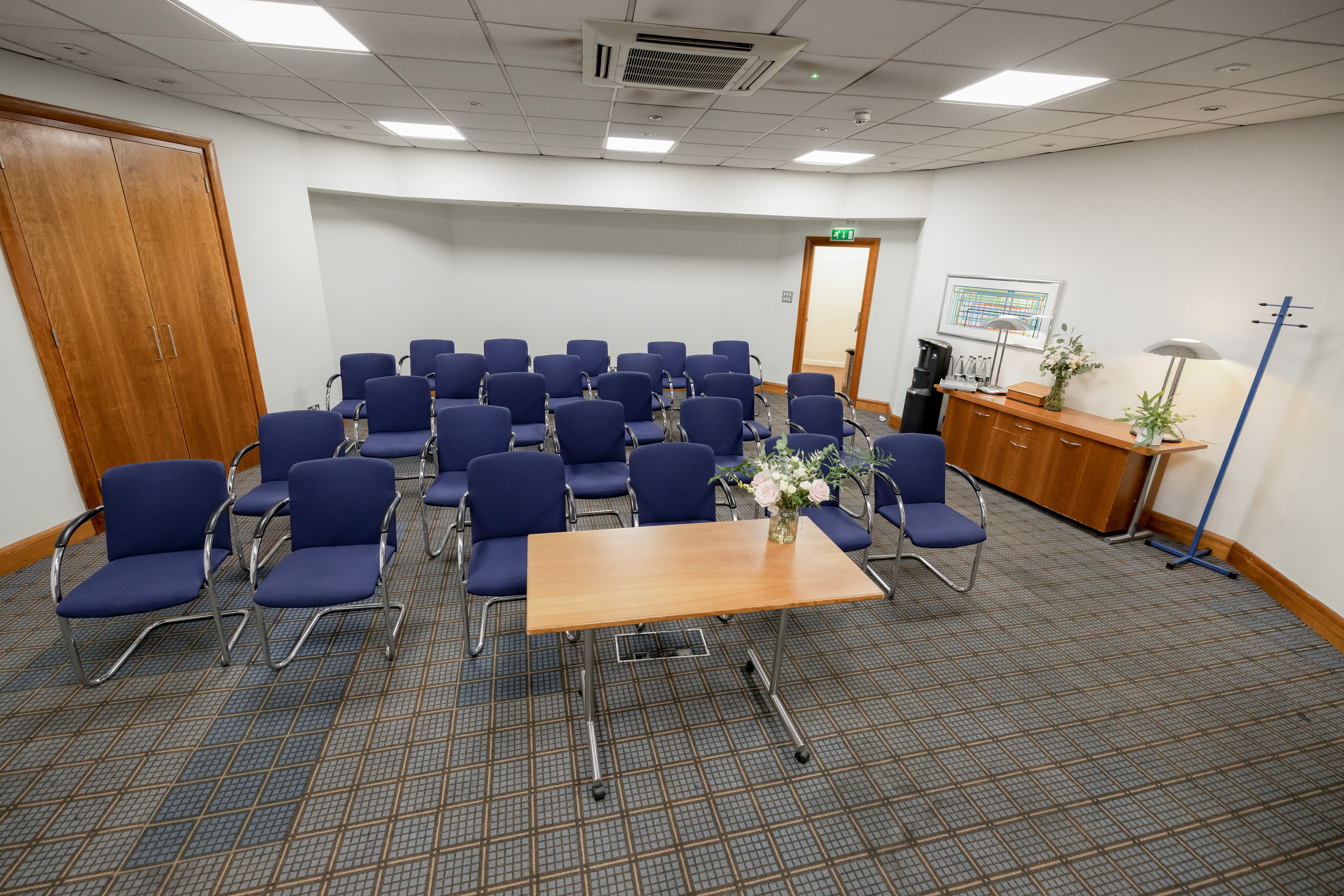 Meeting room at Best Western London Heathrow Ariel, featuring blue chairs for events. - Banner