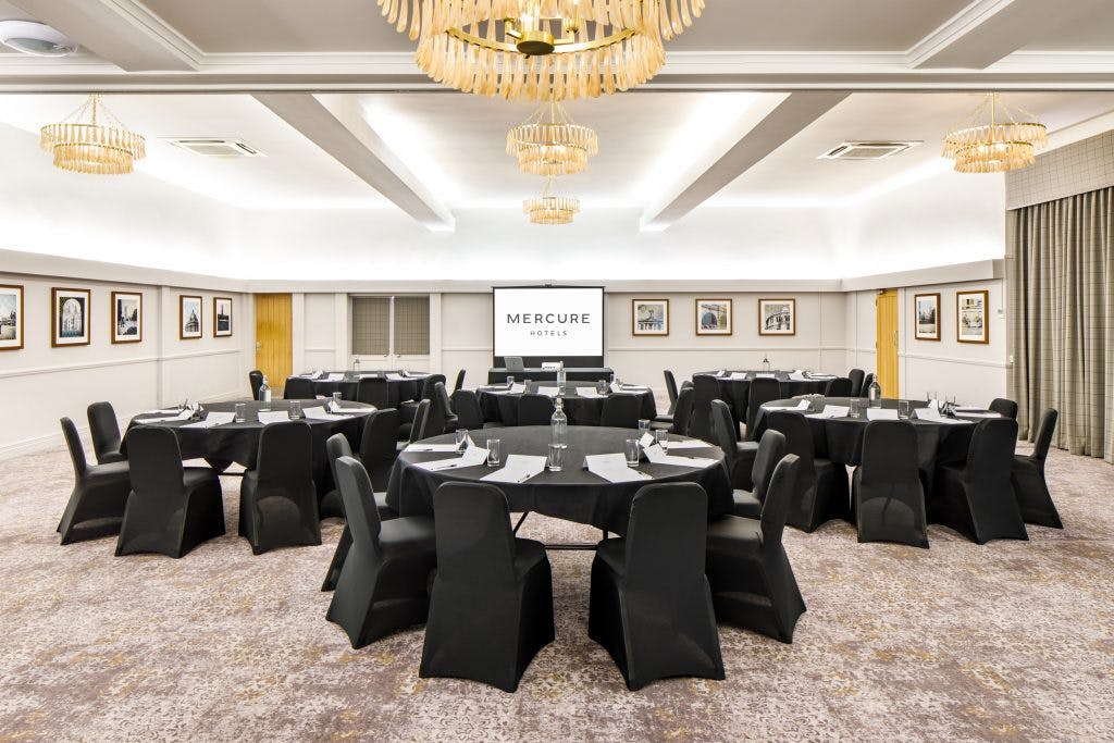 Thames Suite meeting room with round tables, ideal for corporate events and seminars.