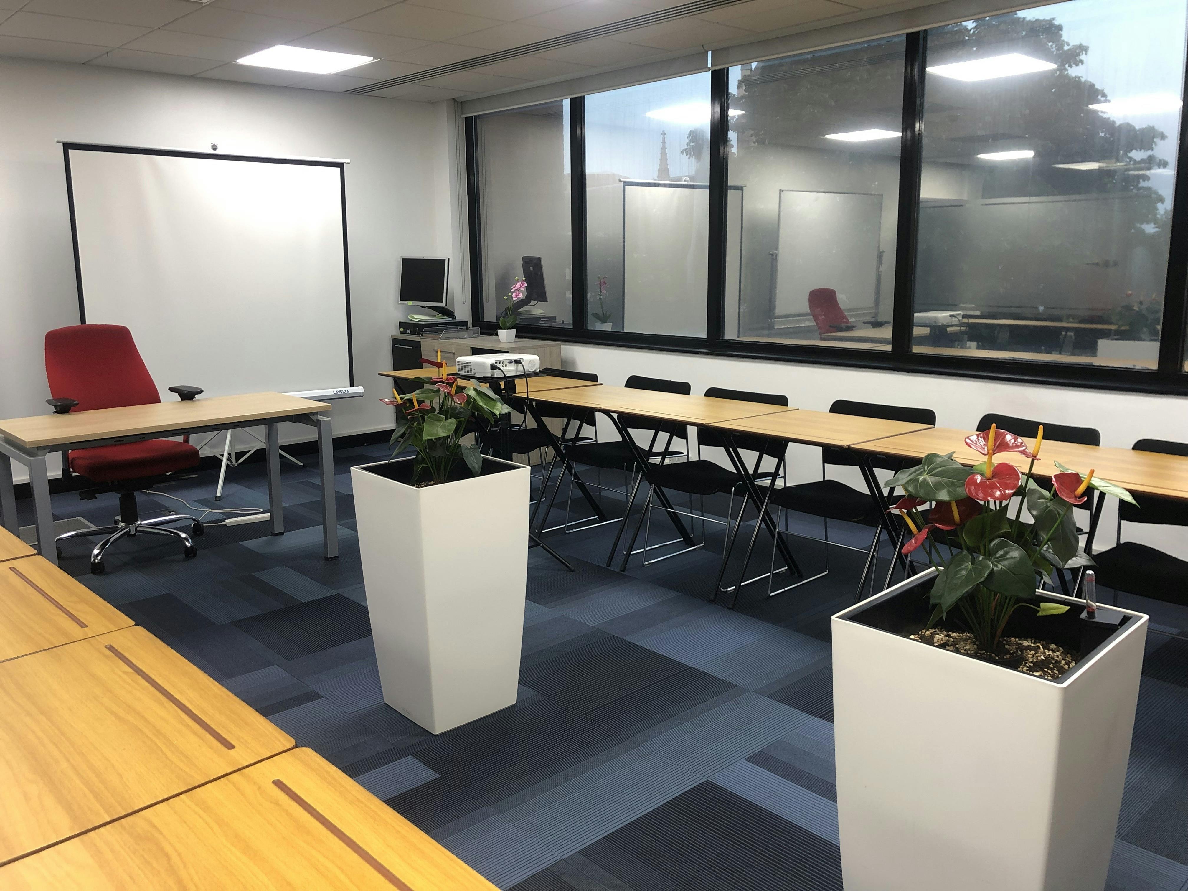 Meeting room at Haliton Properties, Stratford, featuring a central table and red accent chair.