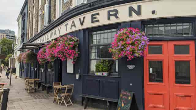 Charming Railway Tavern N16 pub exterior with flower baskets, perfect for networking events.
