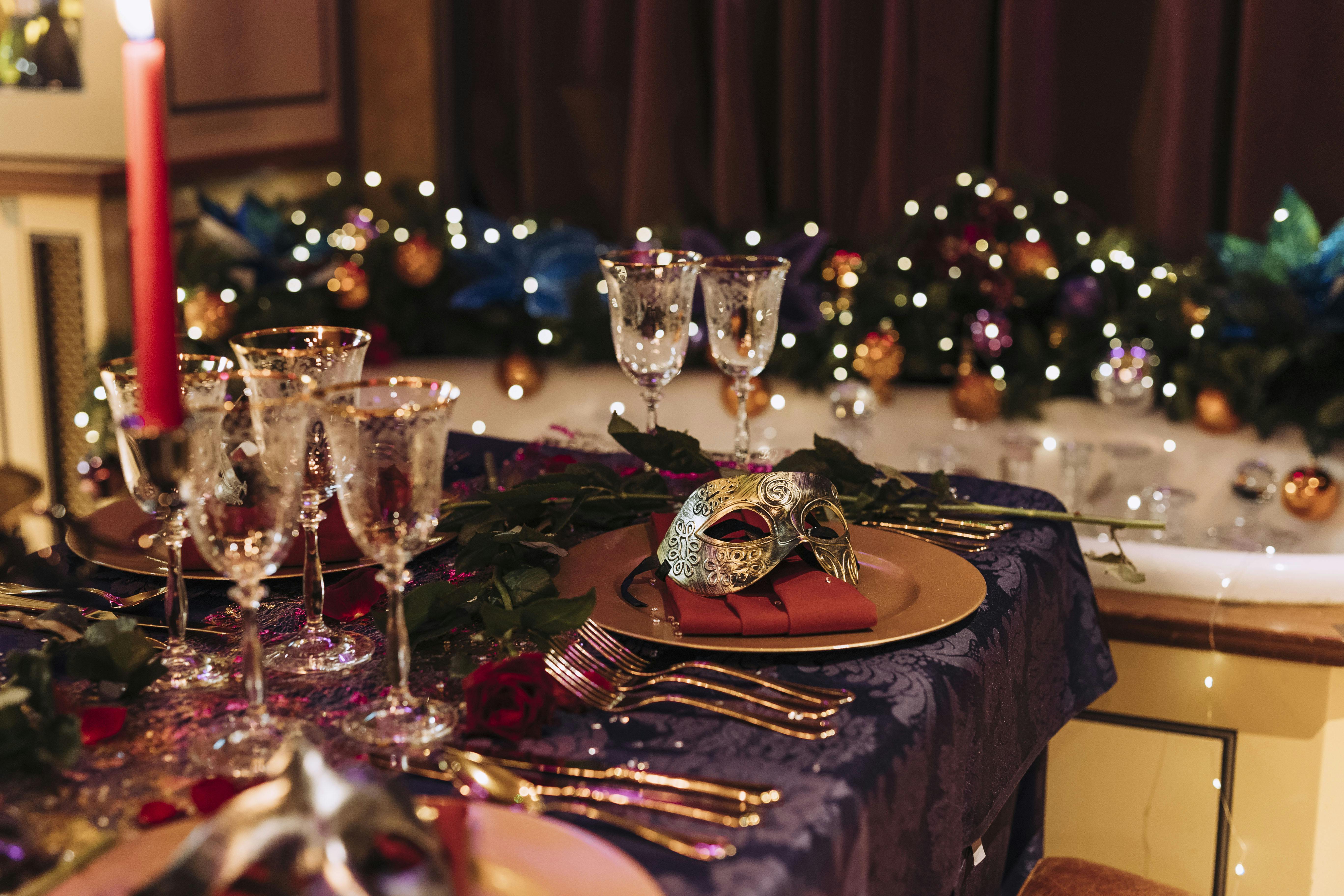 Elegant table setting with mask for Mystical Masquerade Christmas gala in Victorian Bath House.